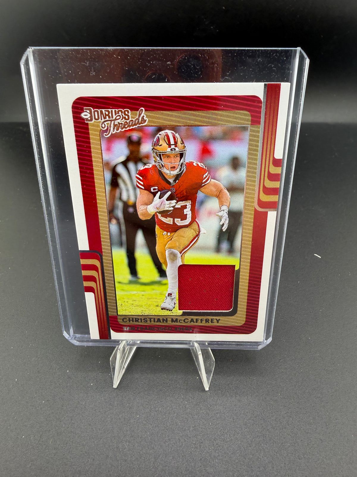 2025 Panini Donruss Threads Christian McCaffrey Memorabilia Card DTH-CMY - front