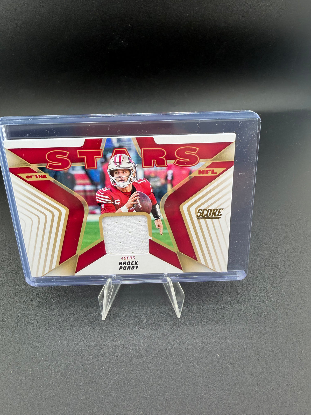 2025 Panini Score Stars of the NFL Brock Purdy Jersey Card SNJ-BPY - front